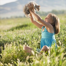 Young girl holding a kitten. Photo. Mike Kemp