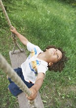 Carefree child swinging. Photo. Shawn O'Connor
