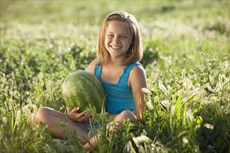 Young girl holding a watermelon. Photo. Mike Kemp