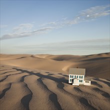Scale model home in desert. Photo. Mike Kemp