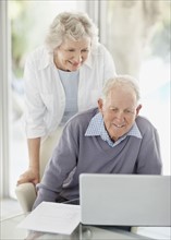 Senior couple browsing the internet together. Photo. momentimages