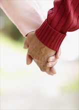Two people holding hands. Photo. momentimages