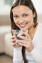 Woman drinking a glass of water. Photo. momentimages