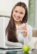 Woman drinking a glass of water. Photo : momentimages