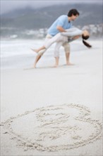 Playful couple at the beach. Photo. momentimages