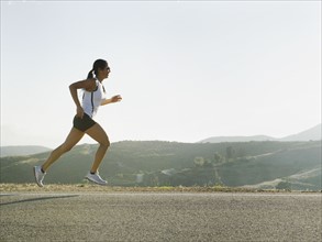 Runner training on the side of the road.