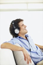 Man listening to music on headphones. Photo. momentimages
