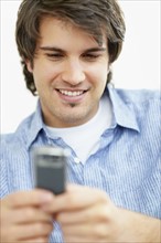 Handsome man texting. Photo. momentimages