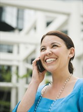 Smiling businesswoman talking on cell phone.