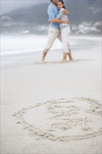 Couple embracing at the beach. Photo. momentimages