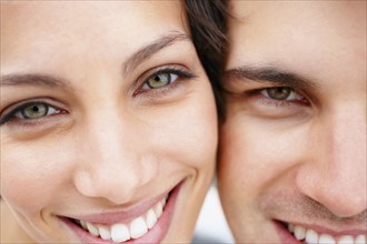 Cropped picture of a smiling couple. Photo. momentimages