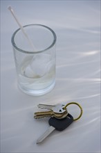 Keys beside alcoholic drink. Photo. Daniel Grill
