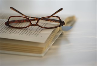 Reading glasses on book. Photo : Daniel Grill