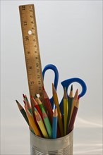 Colored pencils ruler and scissors in can. Photo. Daniel Grill