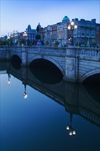 O'connell bridge reflecting in the river liffey.