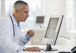 Doctor working on computer.