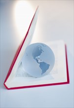 Globe inside a book.