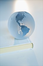 Globe on a book.