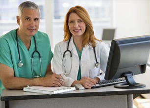 Healthcare professionals working at computer.