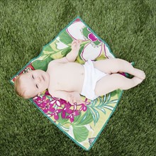 Baby on blanket on the grass. Photo : Jamie Grill
