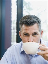 Man drinking coffee.