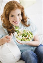Woman eating salad. Photo : Jamie Grill