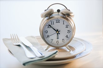 Alarm clock on plate.