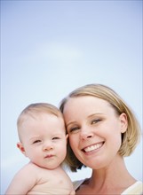 Mother holding her baby. Photo. Jamie Grill