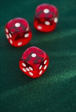 Red dice on green felt. Photo. Daniel Grill