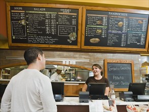 Customer ordering food at bakery. Photo. Erik Isakson