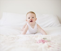 Baby on bed. Photo. Jamie Grill