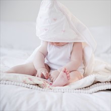 Baby wearing hooded towel. Photo : Jamie Grill