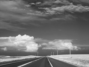 Dark sky over deserted highway. Photo : John Kelly