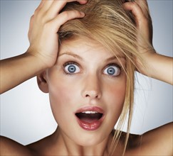 Shocked blond woman. Photo. momentimages
