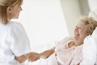 Nurse caring for a senior woman. Photo. momentimages