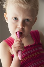 Cute young girl brushing her teeth. Photo. Mike Kemp