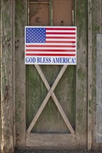 God bless American sign on barn door. Photo. Mike Kemp