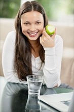 Woman eating an apple. Photo. momentimages