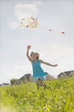 Young girl flying a kite. Photo. Mike Kemp