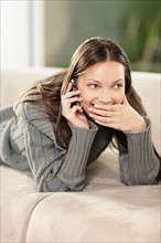 Brunette woman talking on phone. Photo. momentimages