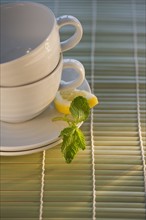 Tea cups on bamboo mat. Photo : Daniel Grill