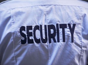Back of security guard`s shirt. Photo : fotog