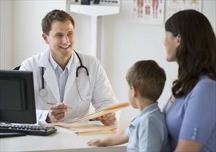 Doctor talking to woman and her son.