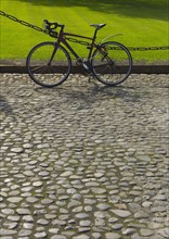 Bicycle on cobblestone path.
