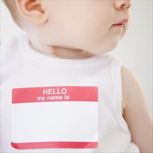 Baby wearing name tag. Photo. Jamie Grill