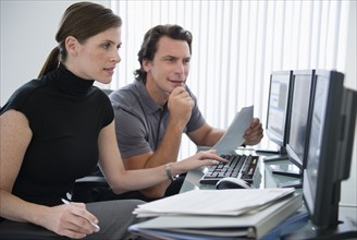 Man and woman working with computers.