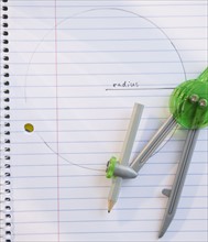 Drawing compass on notebook. Photo : Jamie Grill
