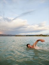 Man swimming in lake.
