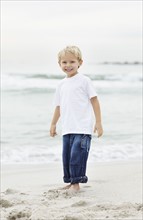 Portrait of boy (4-5) playing on beach. Photo : Momentimages