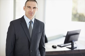 Portrait of businessman in office environment. Photo : Momentimages
